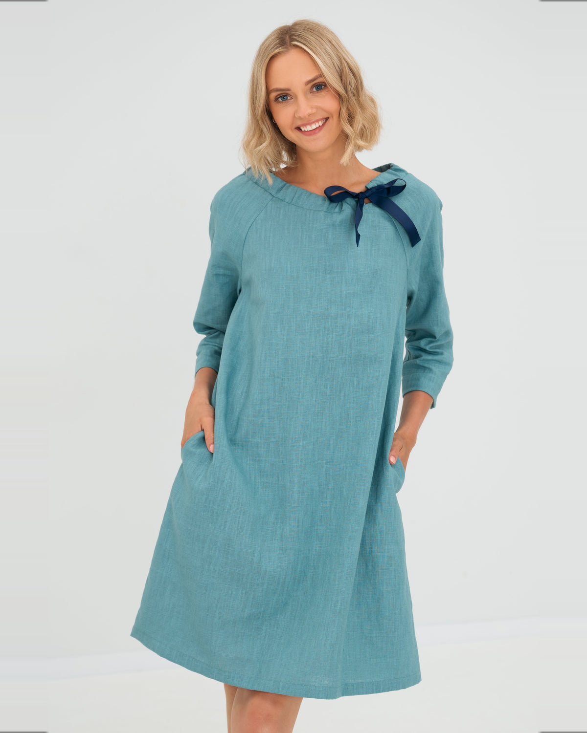 LeMuse FRENCH linen dress in teal – studio side view in motion #Color_Teal