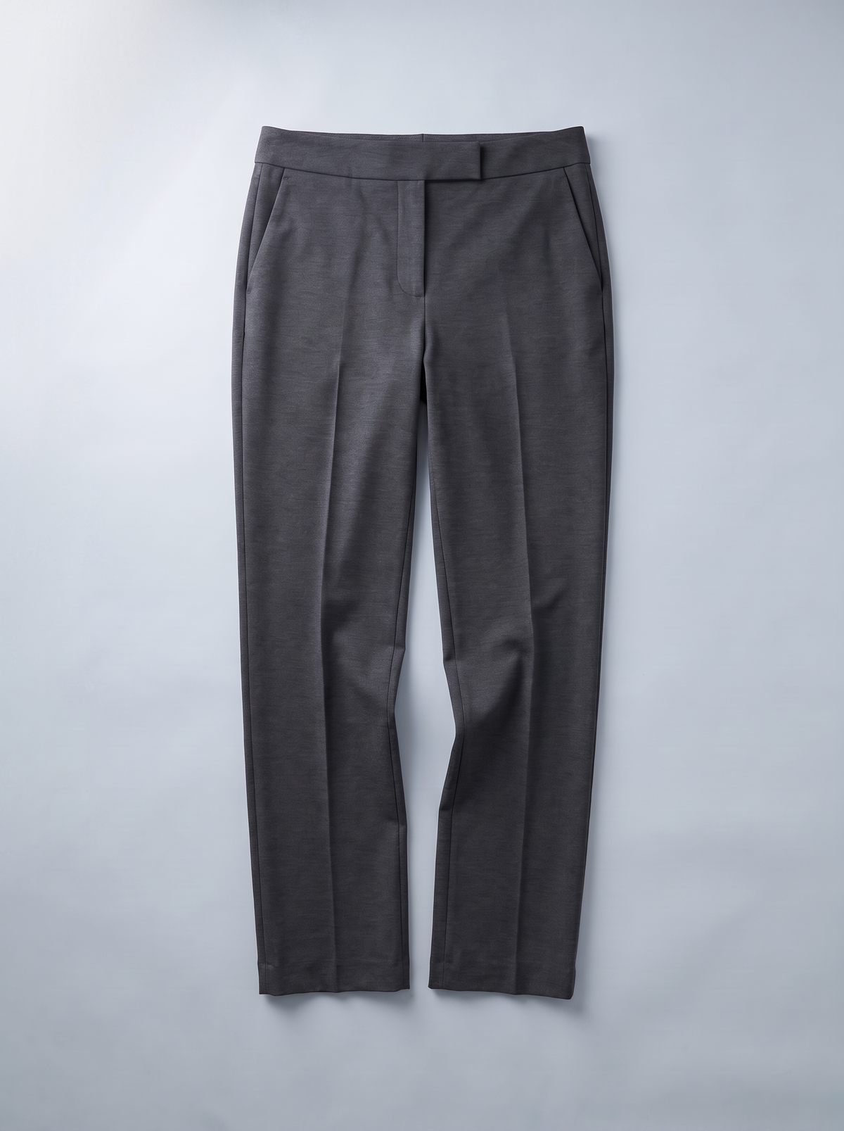 GRAPHITE straight-leg trousers, flat lay on grey background