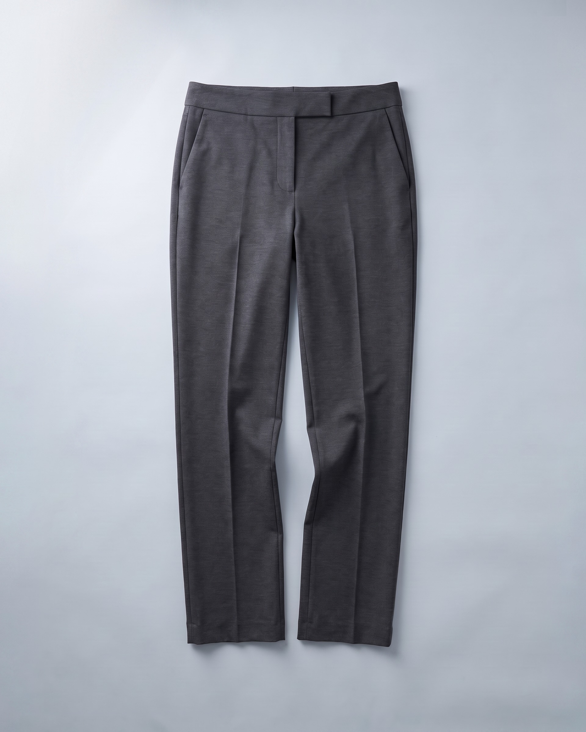 GRAPHITE straight-leg trousers, flat lay on grey background