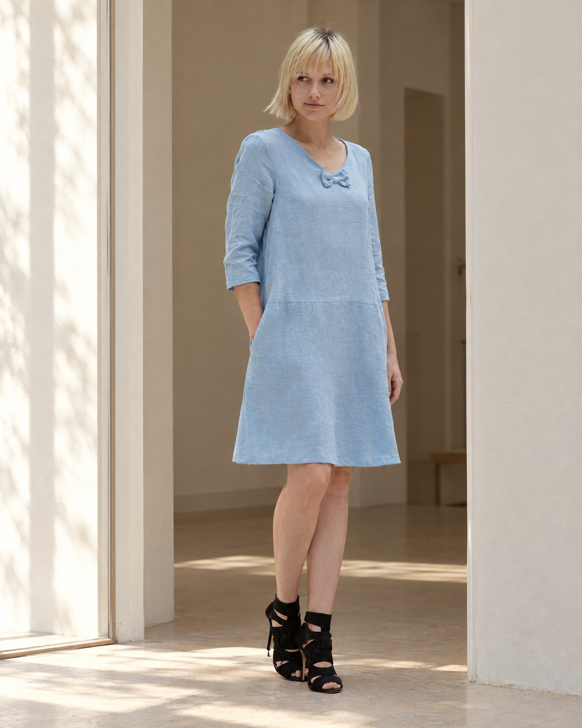 SUN – Linen Blend V-Neck Bow Dress – Light blue dress, lifestyle, sunlit doorway #Color_Light blue