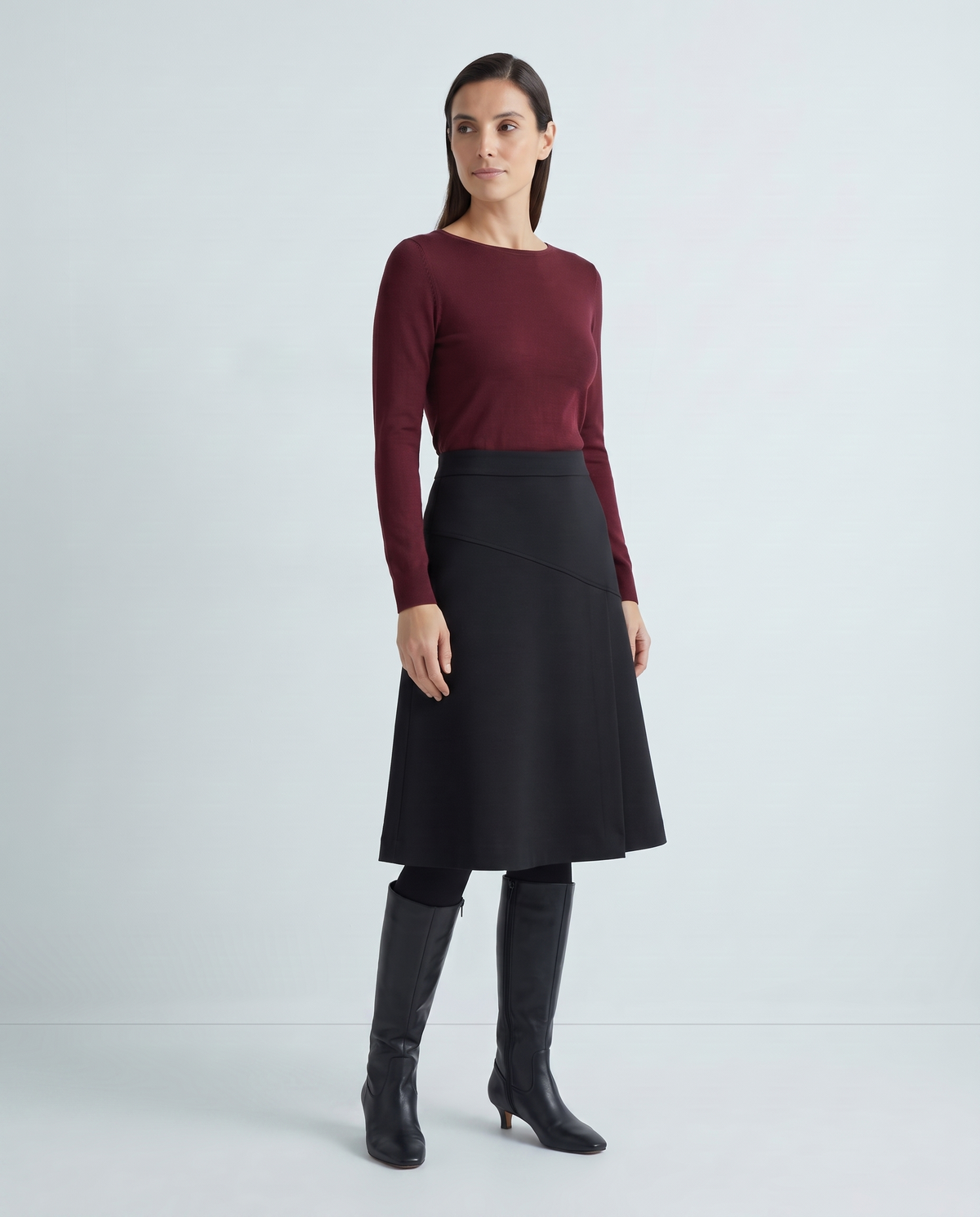 MIDNIGHT black A-line midi skirt, three-quarter view