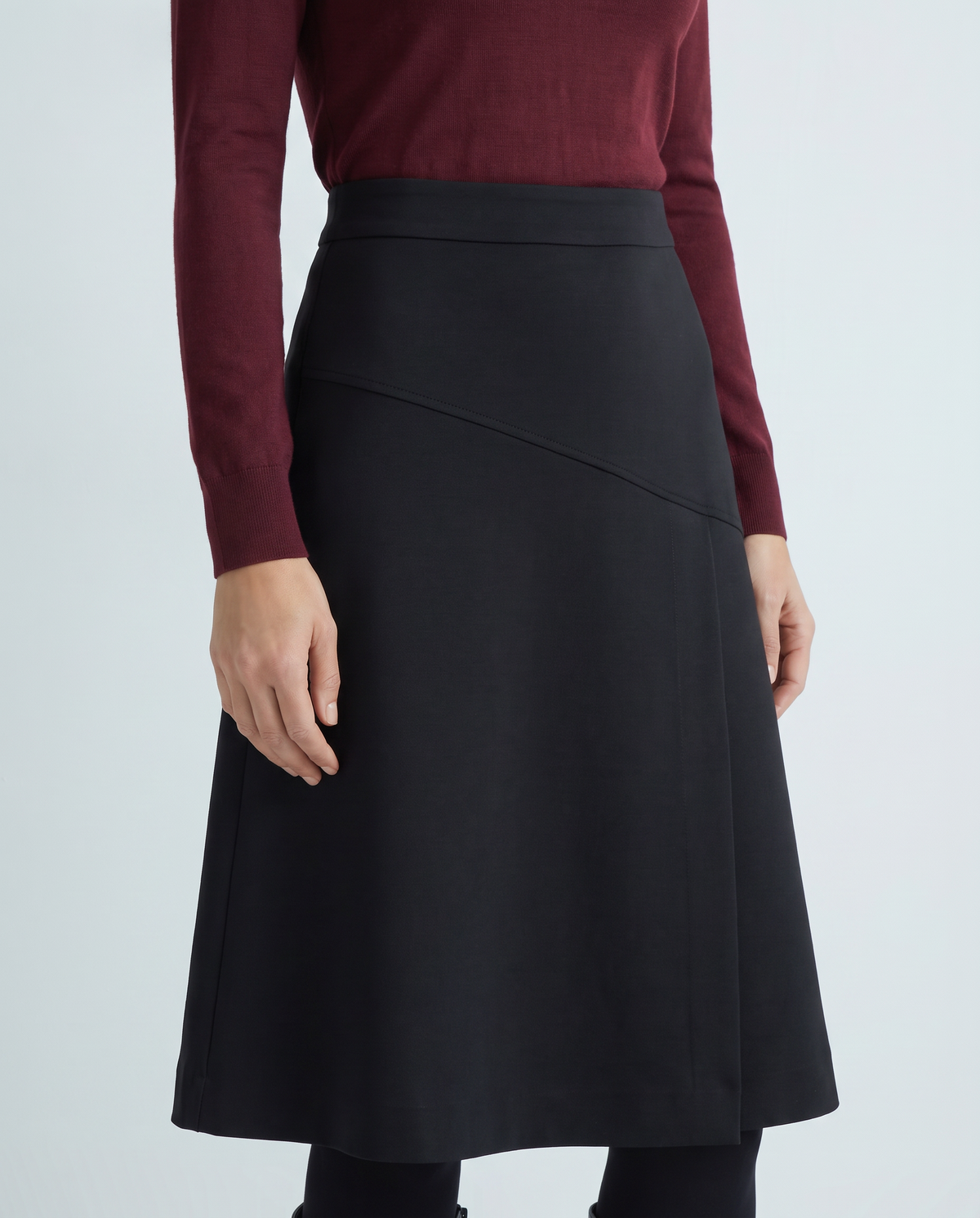 MIDNIGHT black A-line midi skirt, diagonal upper-hip panel detail