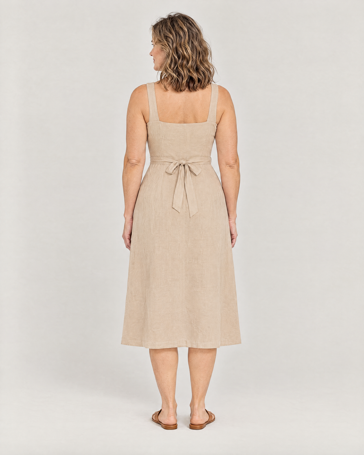 DAYLIGHT beige linen midi dress, back view with square closed back and tied bow