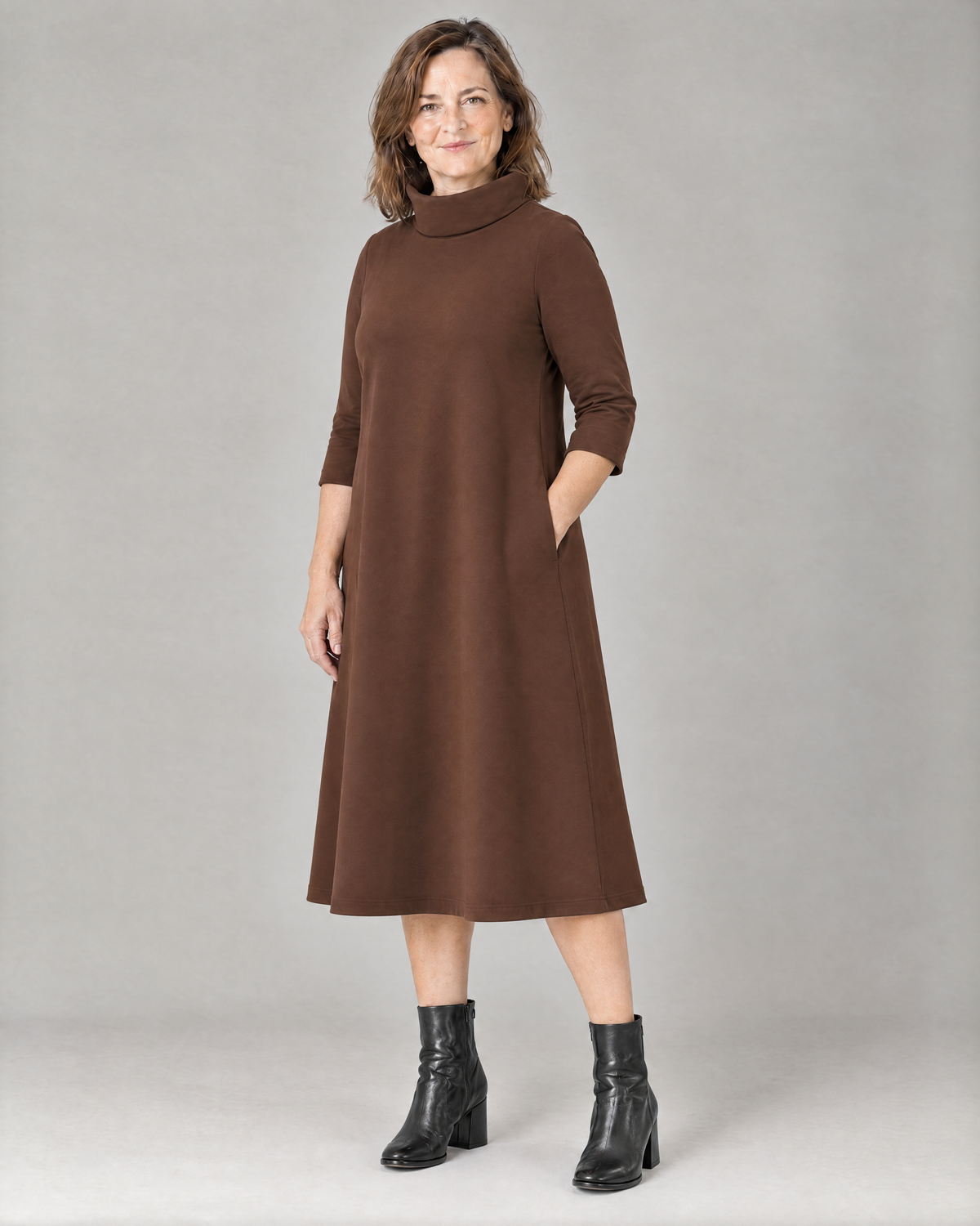 KIND A-line midi dress in Brown, three-quarter view with hand in the side-seam pocket