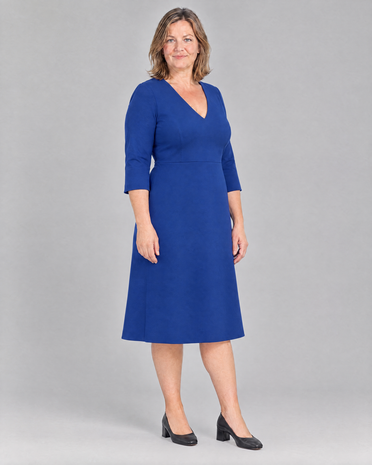 STORY CURVE Punto – cobalt blue A-line dress, three-quarter view on model