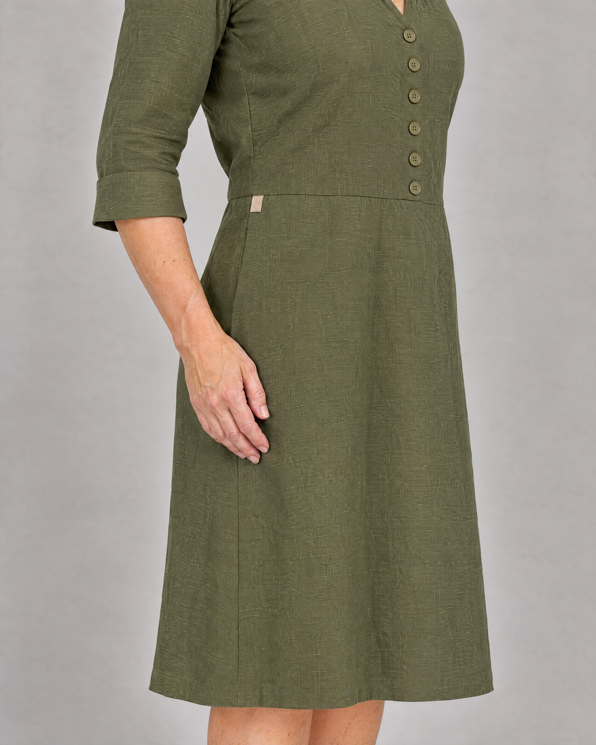 CARRY linen shirt dress, right pocket with a phone inside lying flat and the beige contrast tab