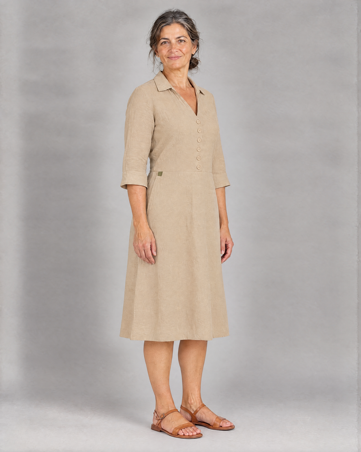 CARRY beige linen A-line midi shirt dress, three-quarter view with olive green tab