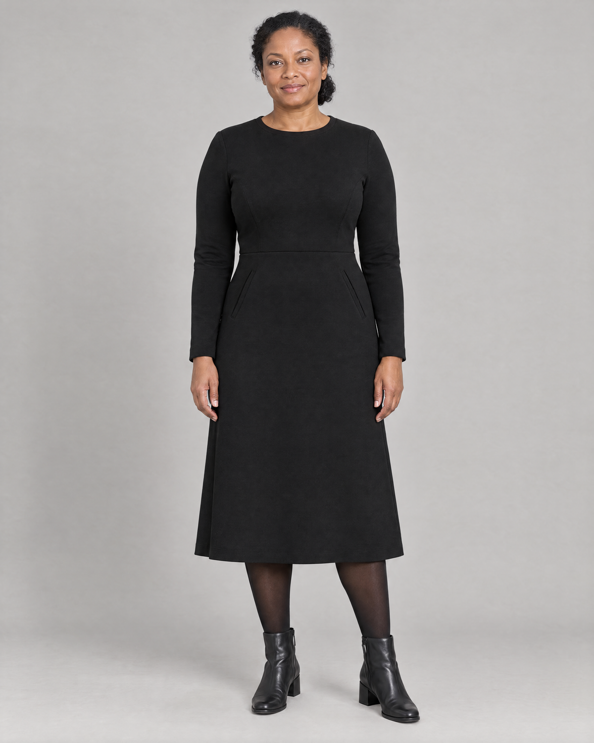 GLIDE black wool A-line midi dress with long sleeves and welt pockets, front view