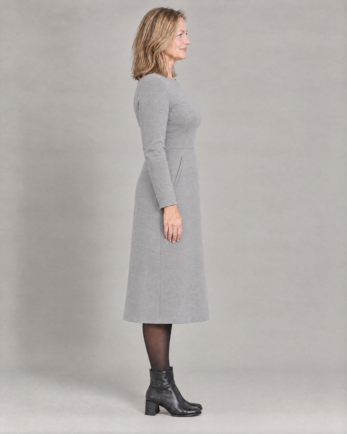 GLIDE light grey wool midi dress, side view showing the gentle A-line skirt