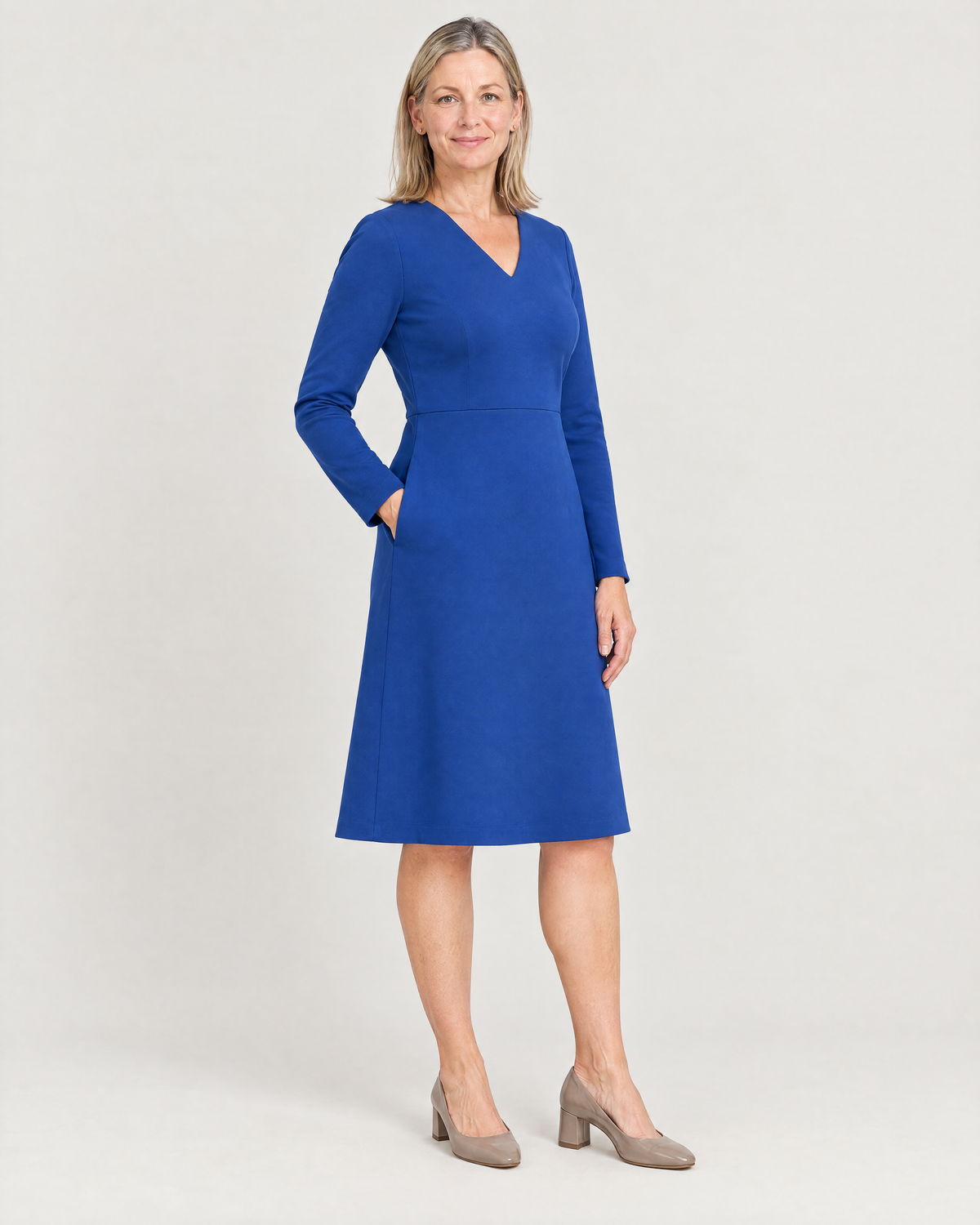 DESK cobalt dress, three-quarter view with hand in the side-seam pocket