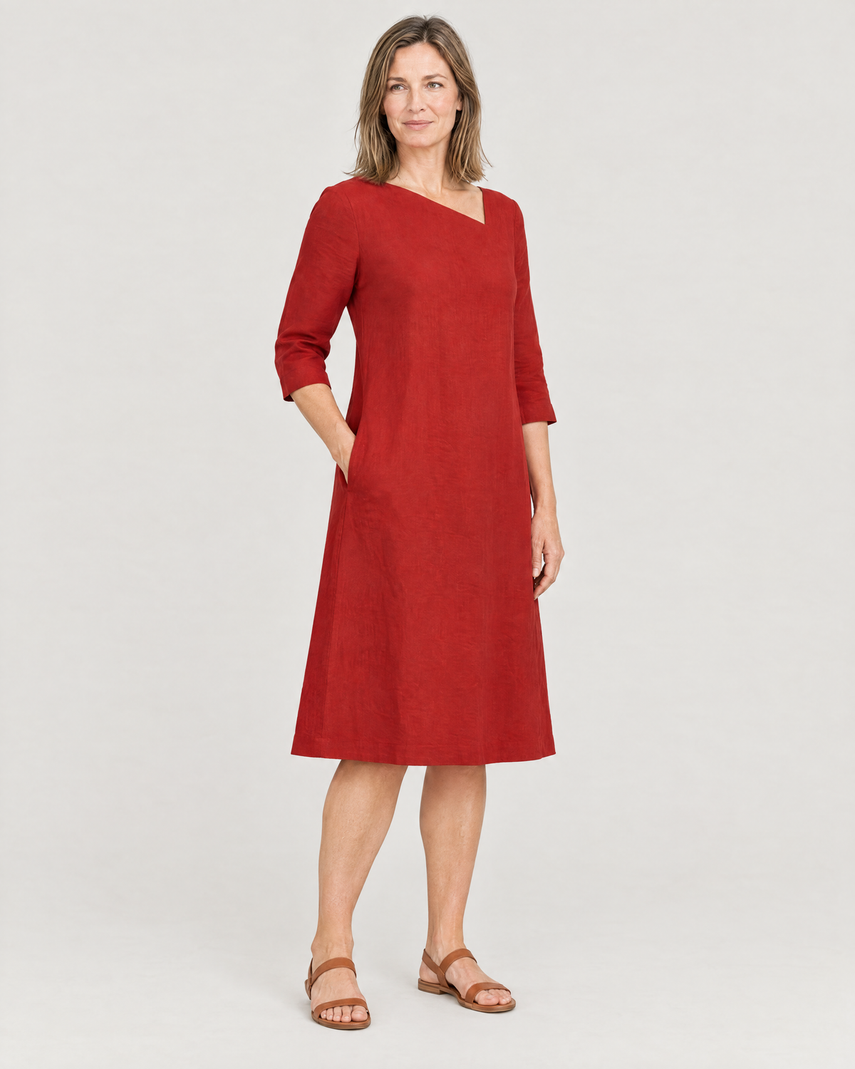 HUE red linen dress, three-quarter view with a hand in the side-seam pocket