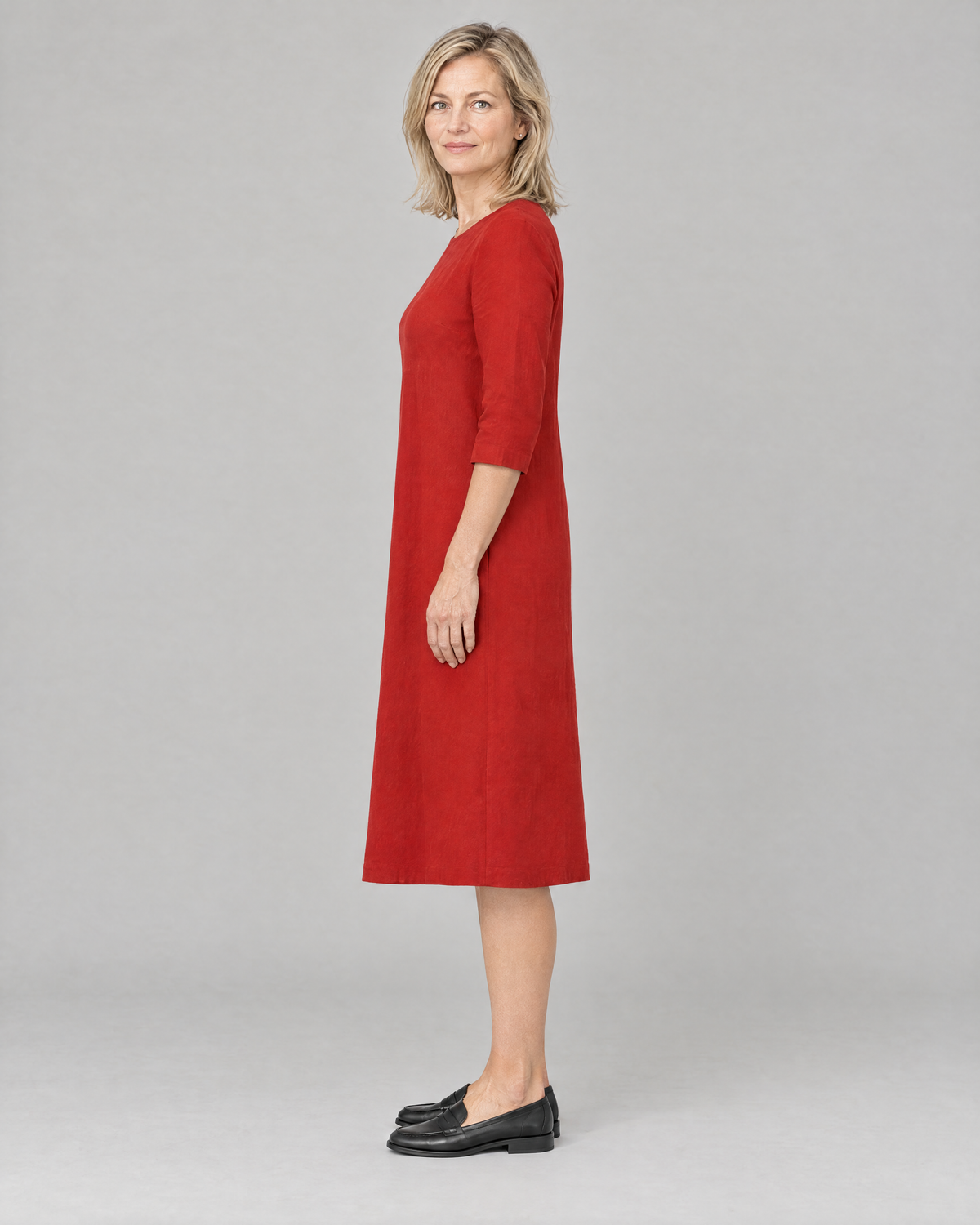 BASE red linen dress, side view showing the gentle A-line and below-the-knee length