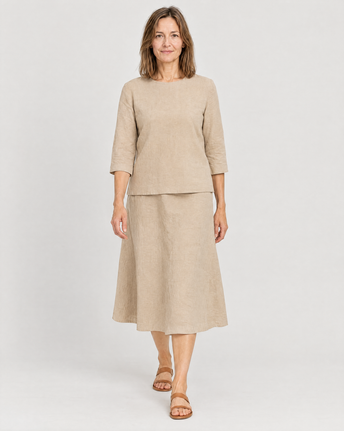 Woman walking in the PAIR beige linen top and A-line midi skirt