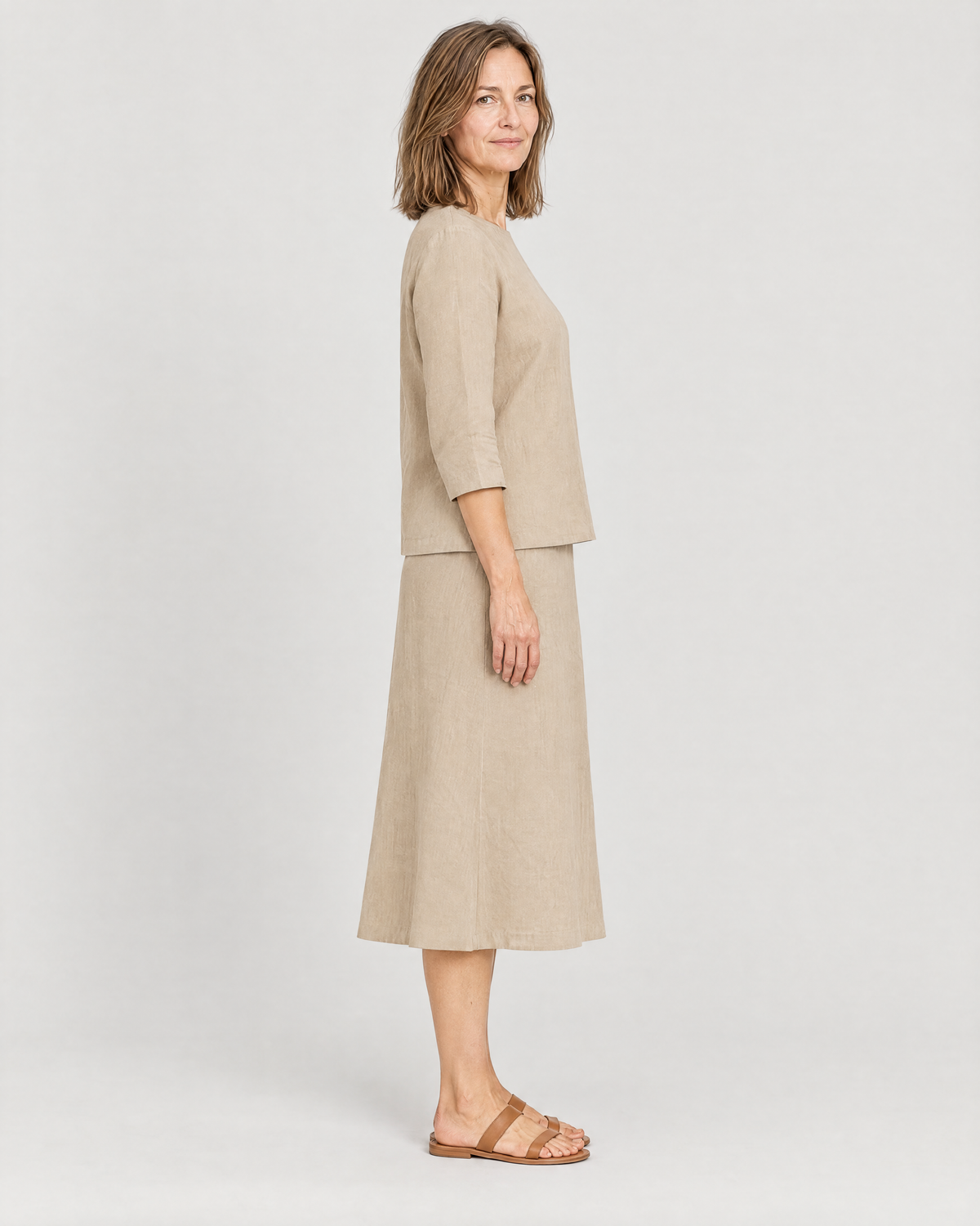 PAIR beige linen set, side view showing the gentle A-line midi skirt