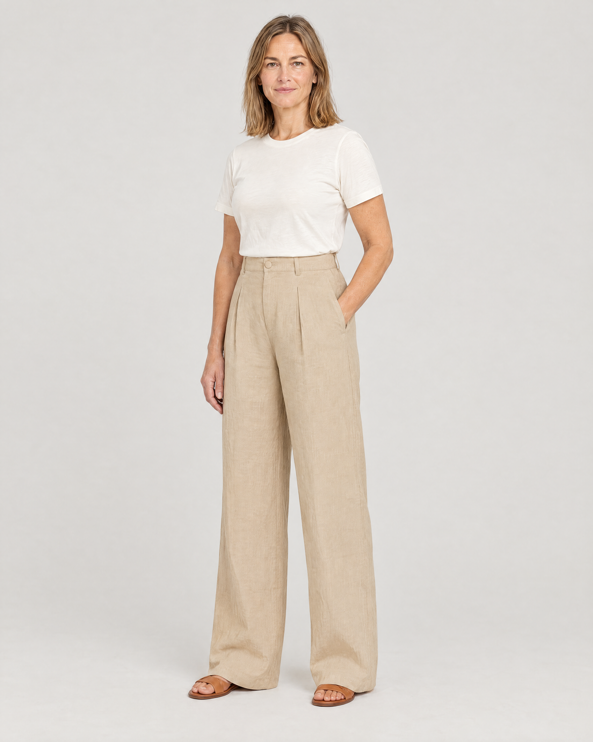 LYRA OPAQUE beige linen wide-leg trousers, three-quarter view with a hand in the side-seam pocket