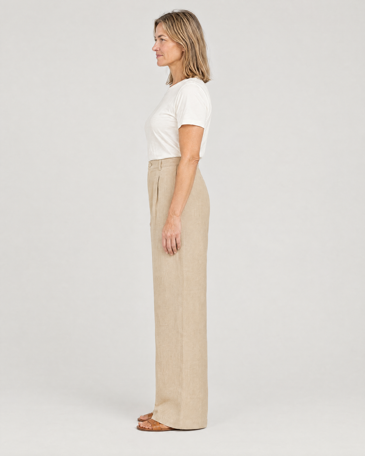 LYRA OPAQUE beige linen trousers, side view showing the high waist and straight wide leg