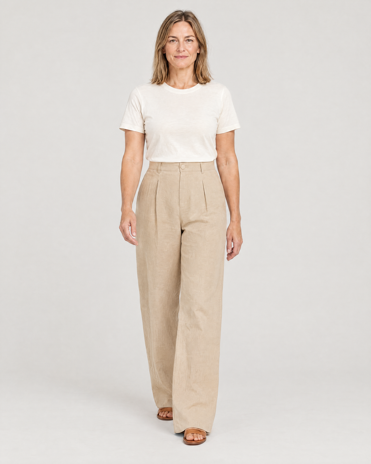 Woman walking in LYRA OPAQUE beige linen wide-leg trousers