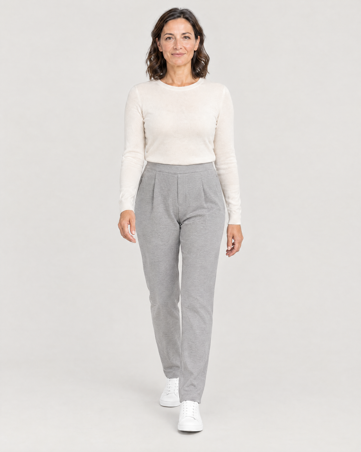 Woman walking in TRAVEL WARM light grey wool tapered trousers