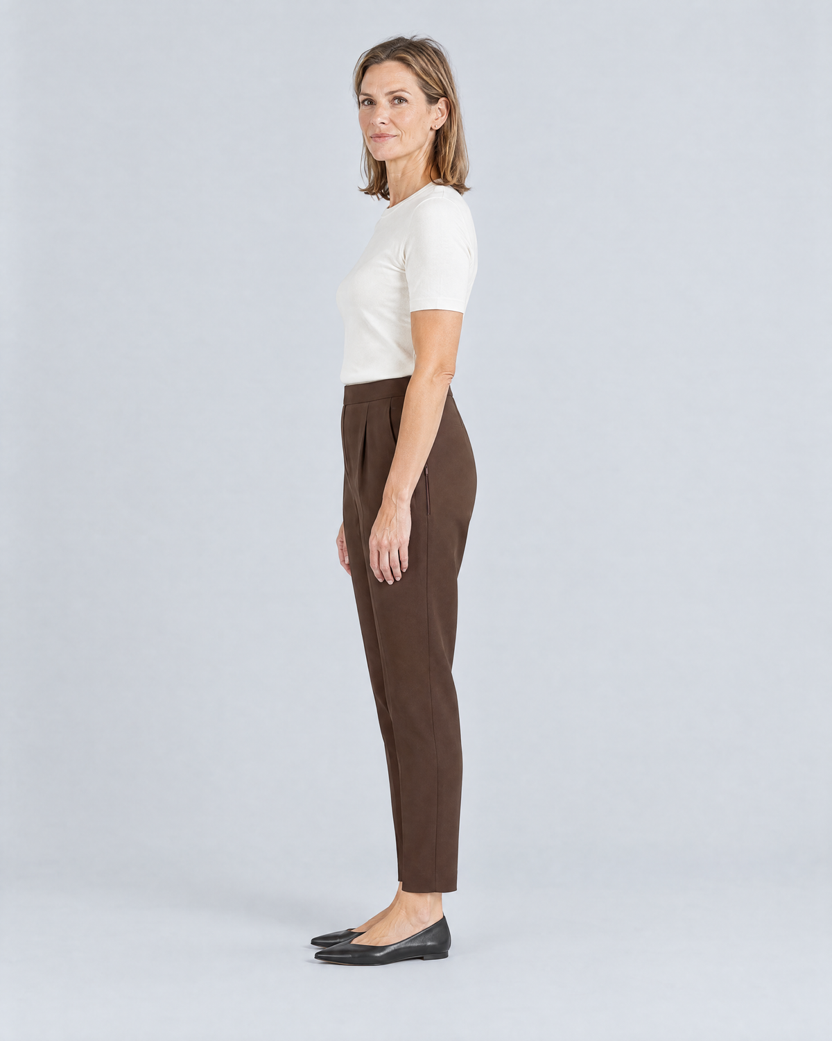 SIT WELL brown trousers, side view showing room through the hip and the taper to the ankle