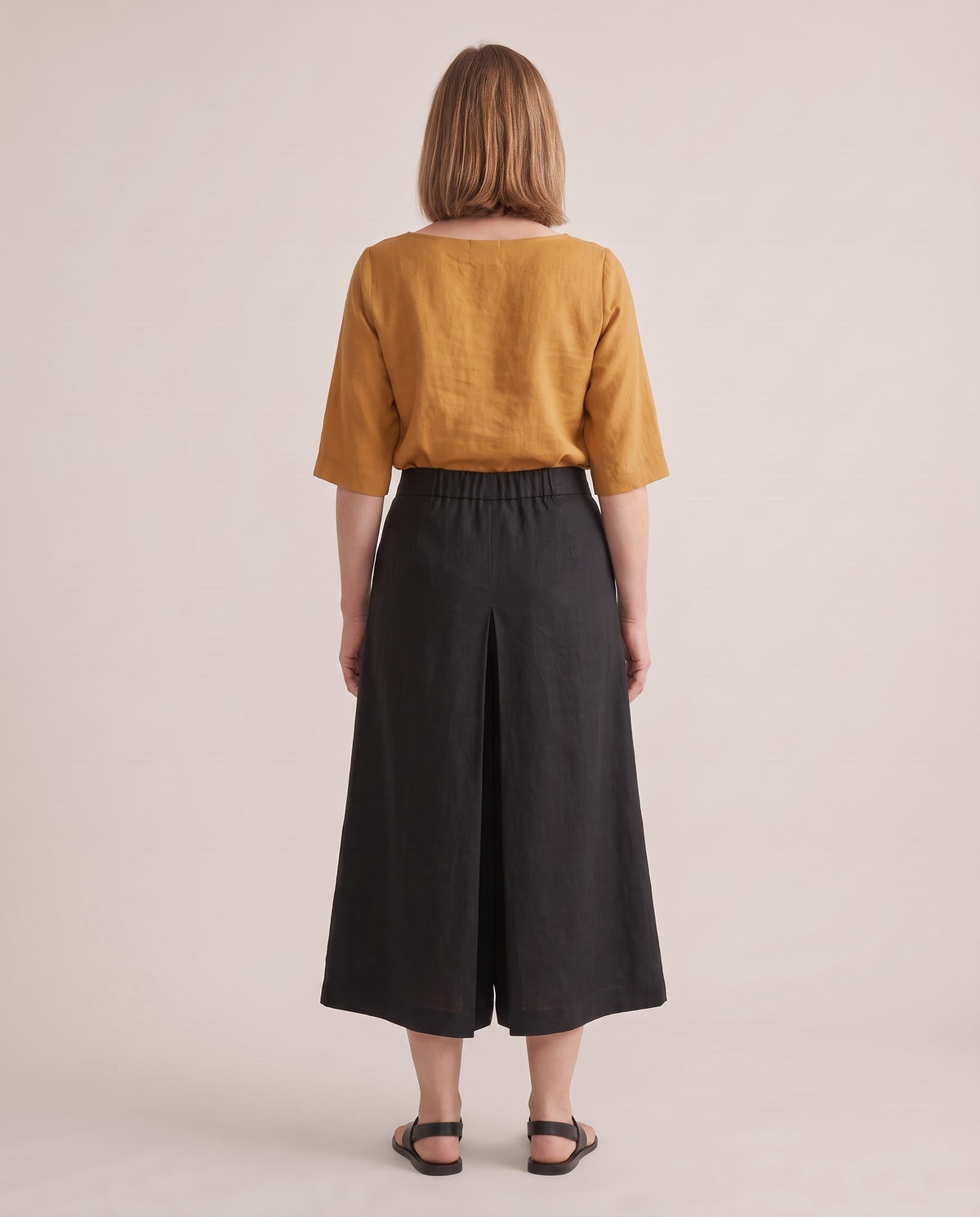 SWAY linen culottes in Black, back view with inverted pleat