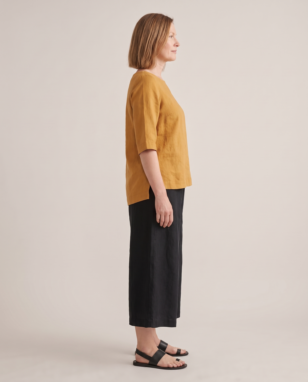 LIFT linen top in Ochre, side view with longer back hem