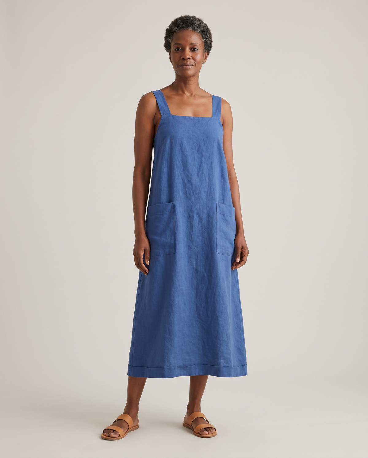 LAYER linen pinafore dress in Blue worn on its own, front view
