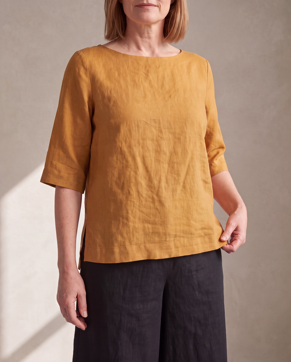 LIFT linen boat-neck top in Ochre worn untucked over black linen midi culottes