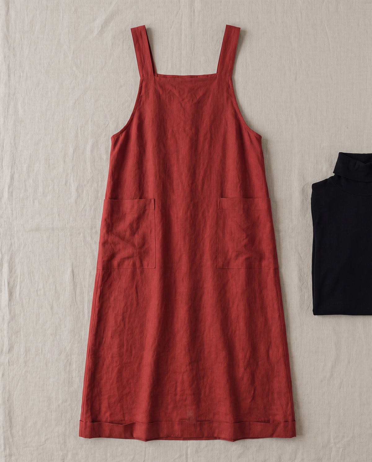 LAYER linen midi pinafore dress in Red laid flat