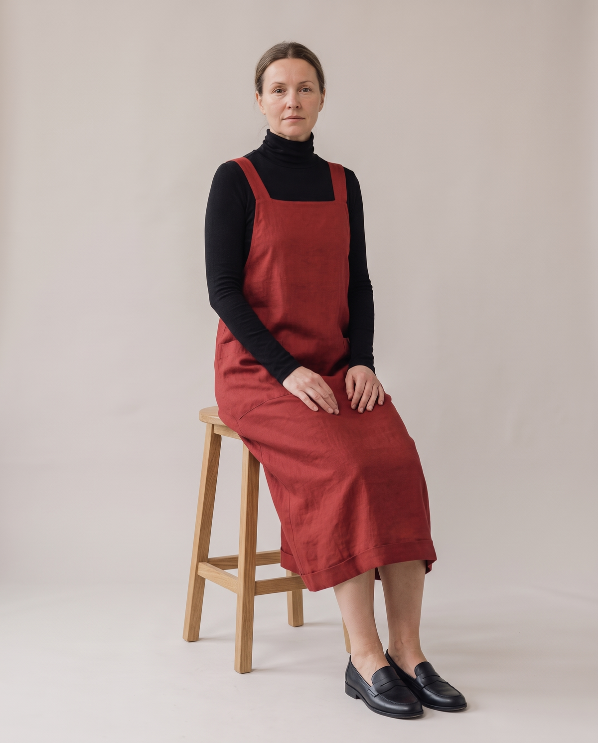 LAYER linen pinafore dress in Red, seated