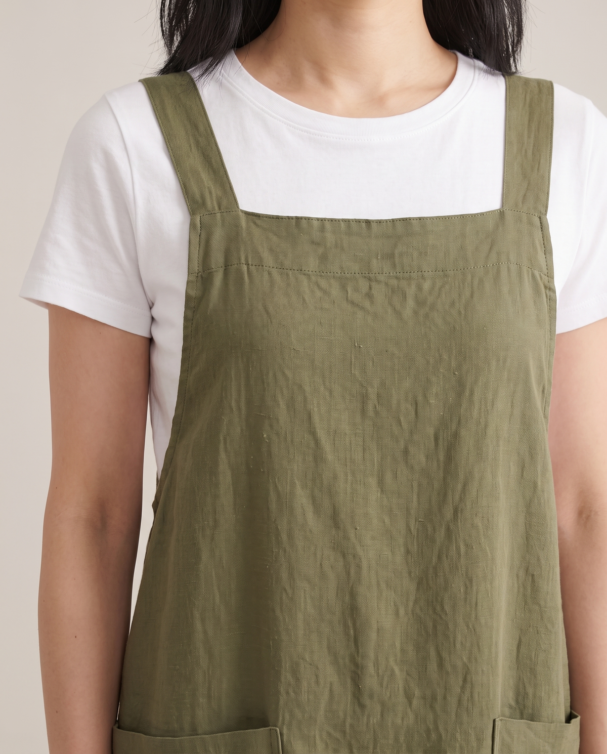 LAYER linen pinafore dress in Olive Green, neckline and pocket detail