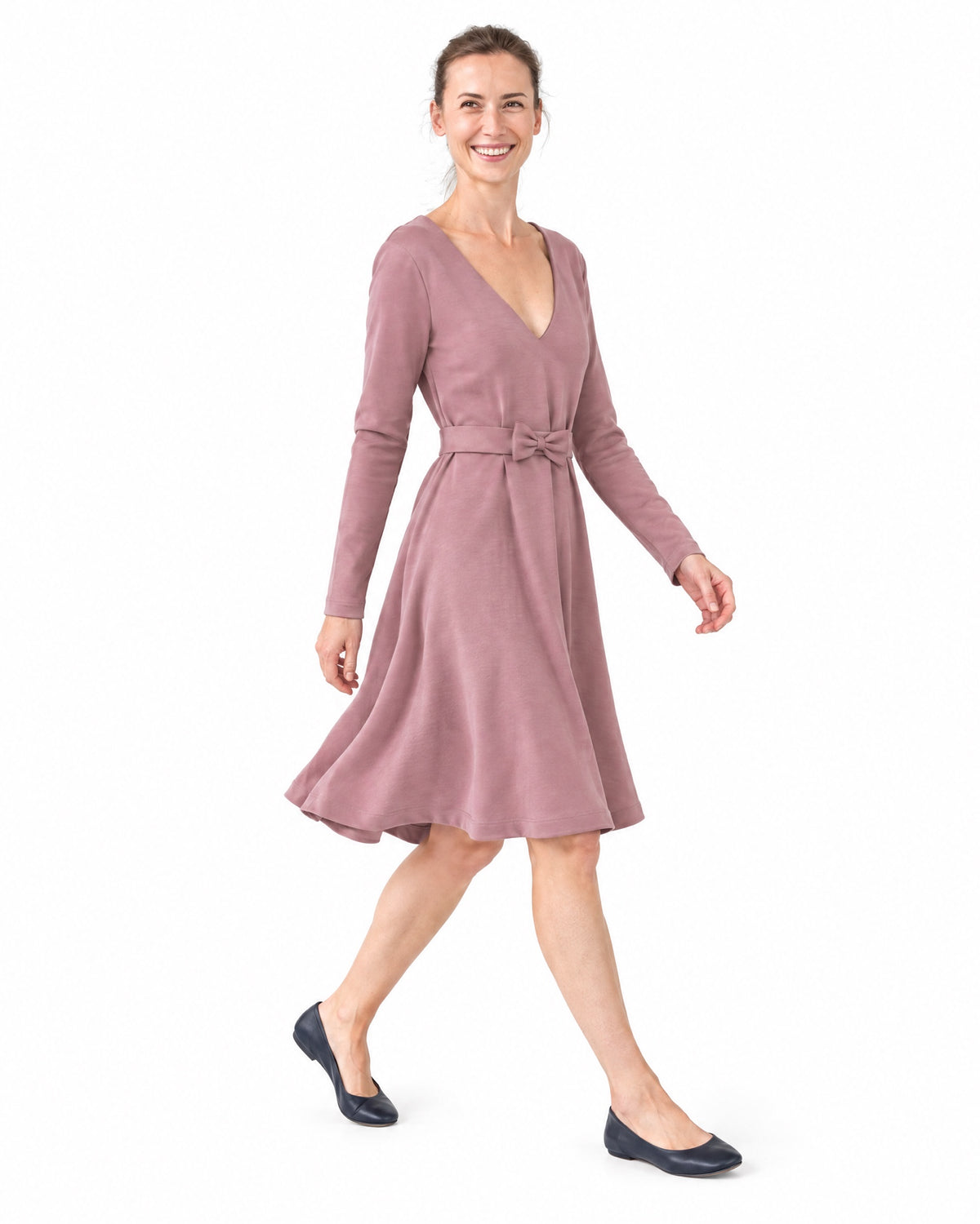 A woman walking in a dusty rose long-sleeve Punto Milano dress, side view showing the A-line skirt in motion. #Color_Dusty rose
