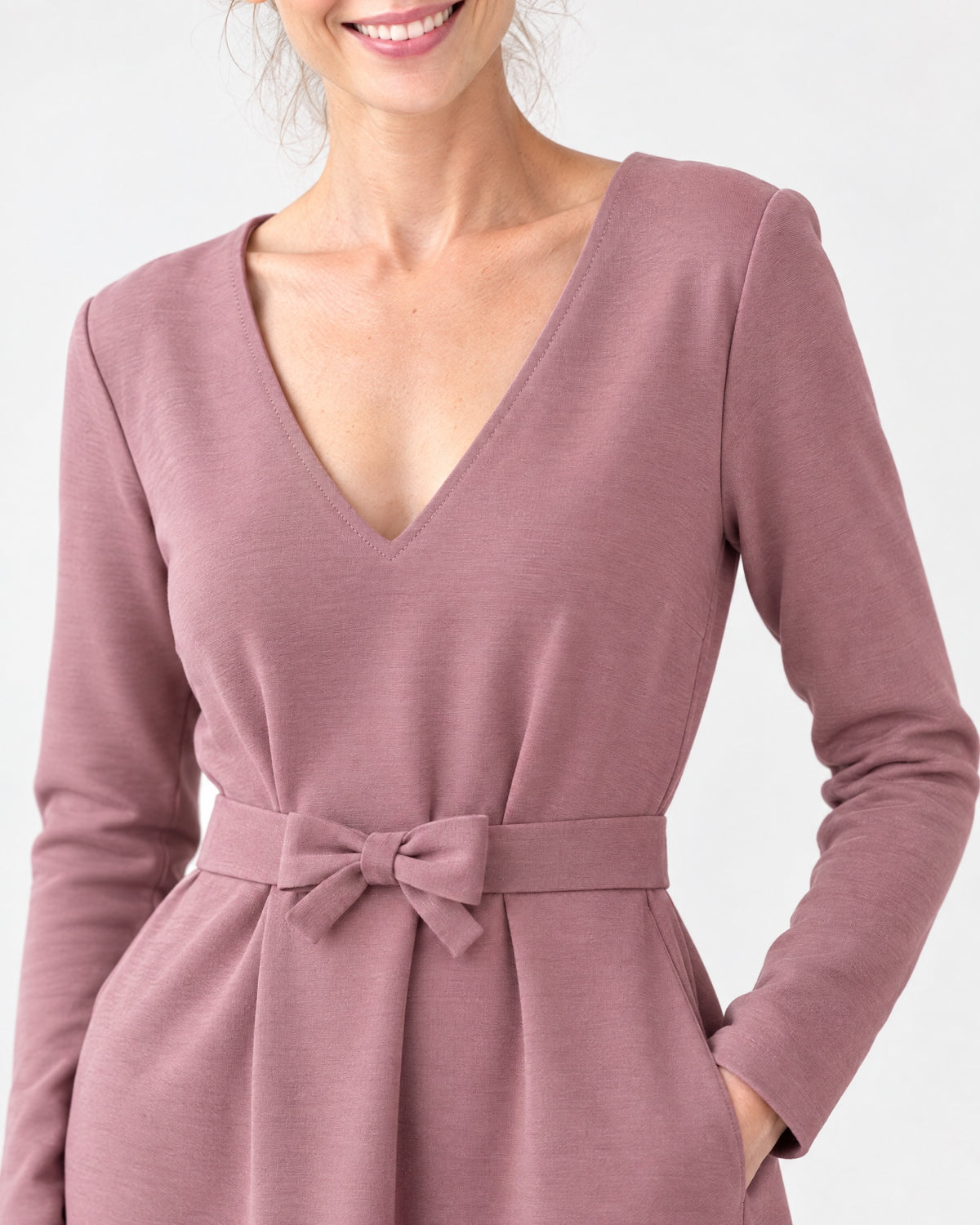 Close-up of the dusty rose Punto Milano dress fabric, V-neckline and tie belt bow detail. #Color_Dusty rose