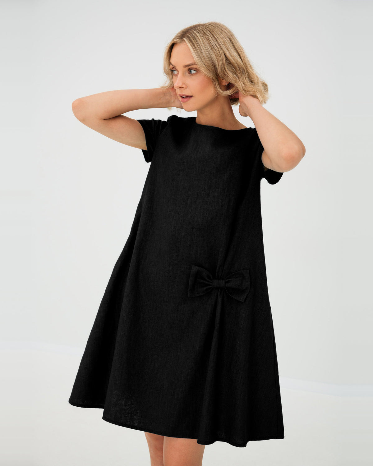 LeMuse SUMMER KISS linen dress in black – studio front view, hands in hair #Color_Black