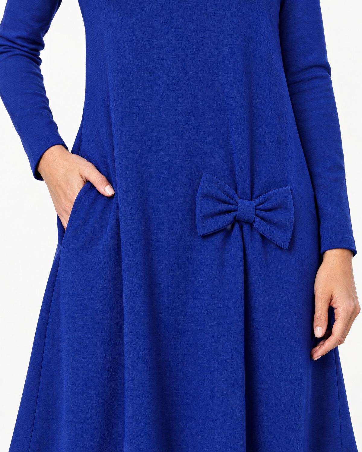 Close-up of a sapphire blue long-sleeve A-line dress showing the side pocket, bow detail and Punto Milano knit fabric texture. #Color_Sapphire blue