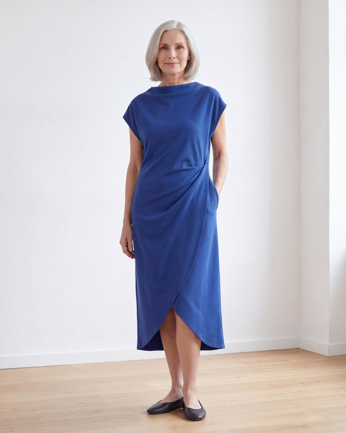 LIVIA cobalt drape midi dress, front view in a bright room