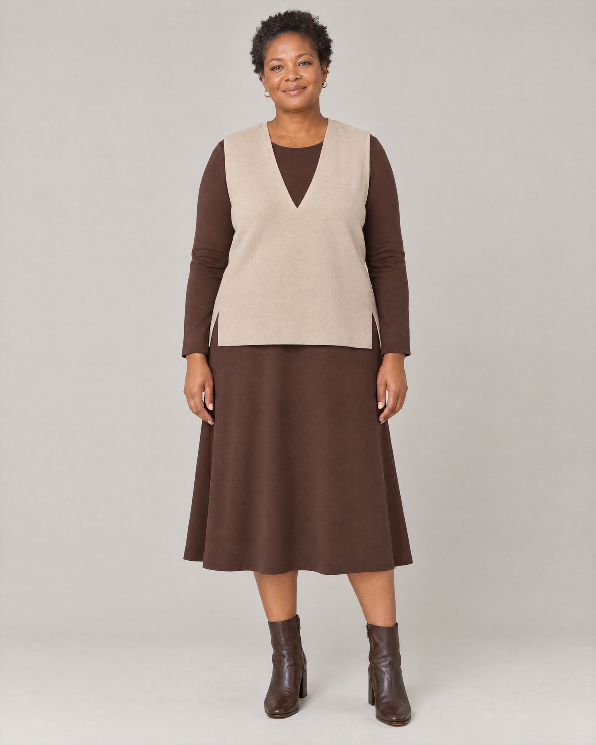 LIGHT VEST in beige fine wool worn over a brown midi dress, front view