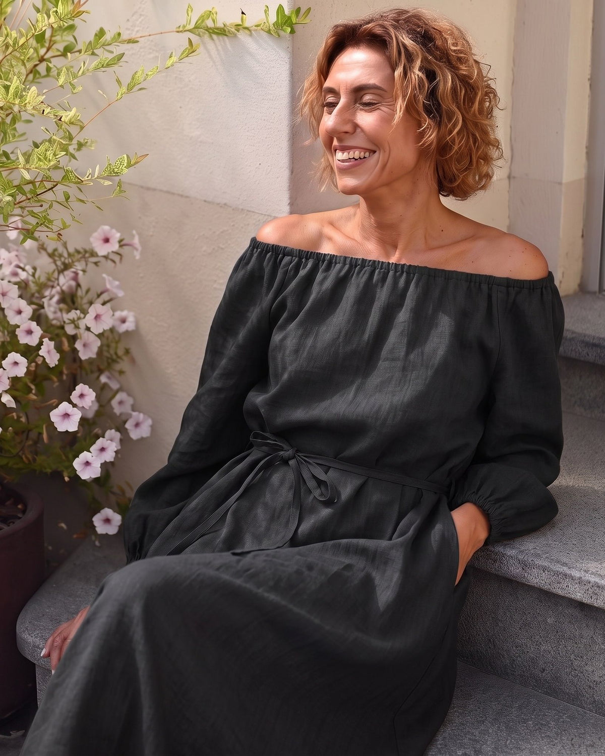 MOON – Black off-shoulder linen midi dress, lifestyle on steps #Color_Black