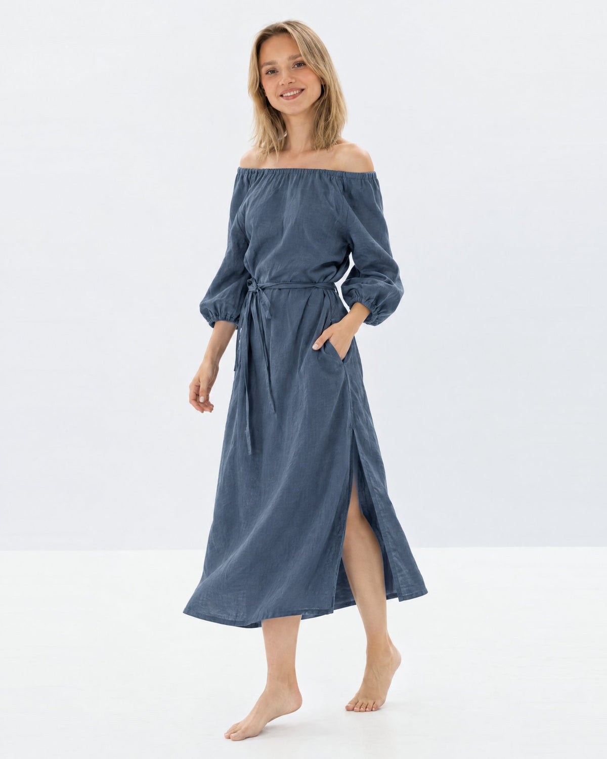 MOON – Blue off-shoulder linen midi dress, side view walking in studio #Color_Blue