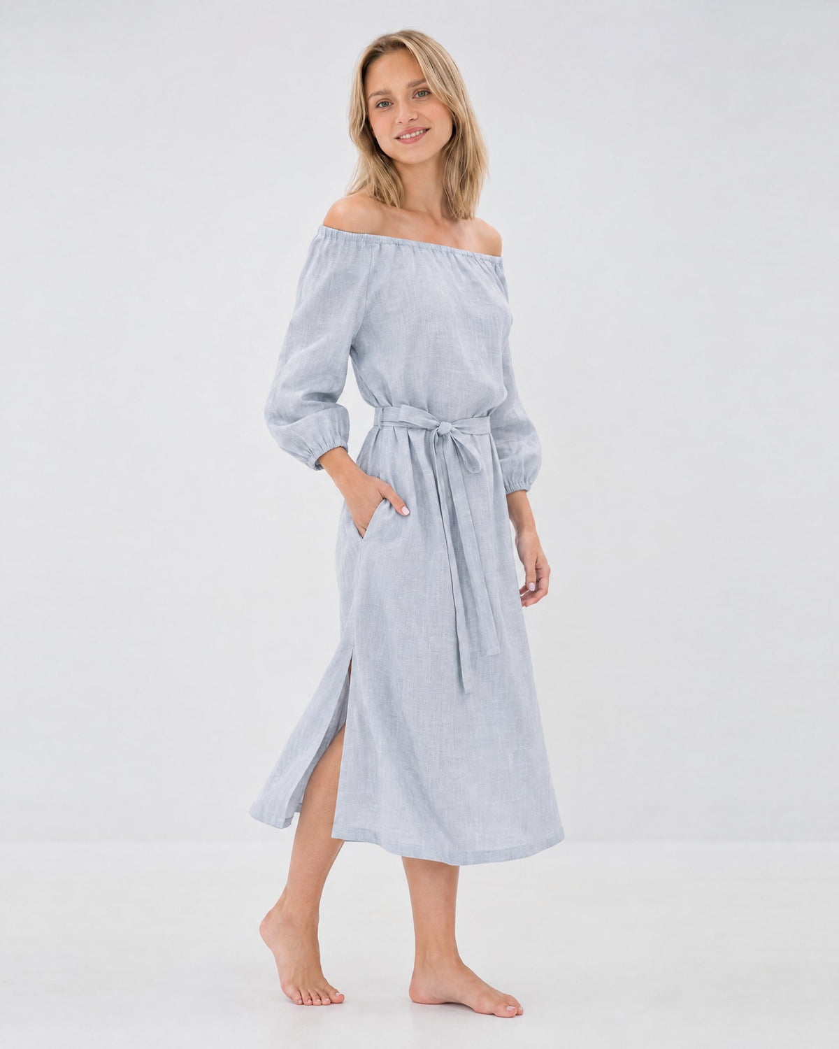 MOON – Light blue off-shoulder linen midi dress, side view walking in studio #Color_Light blue