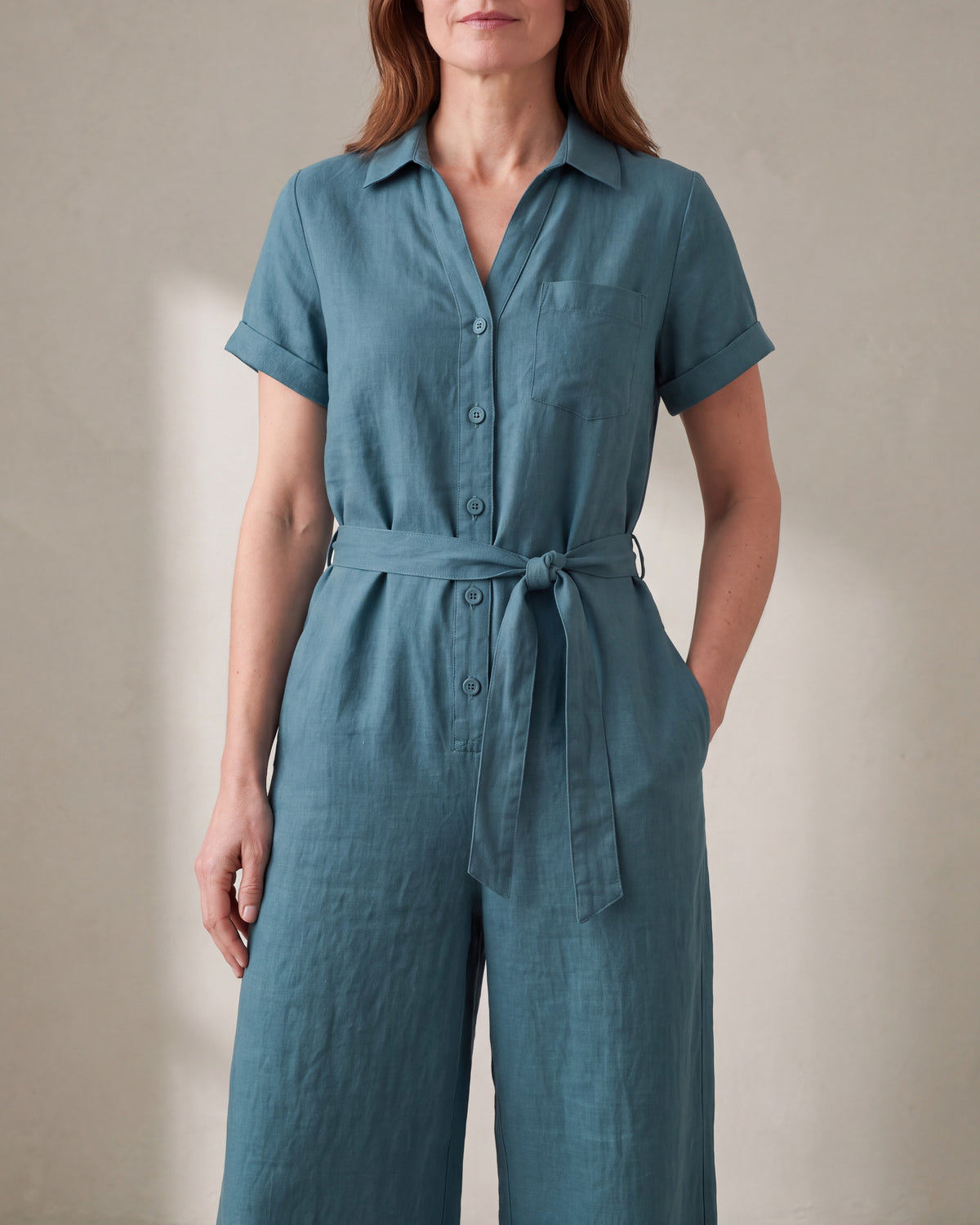 ONE linen wide-leg jumpsuit in Teal with tie belt, hand in side pocket