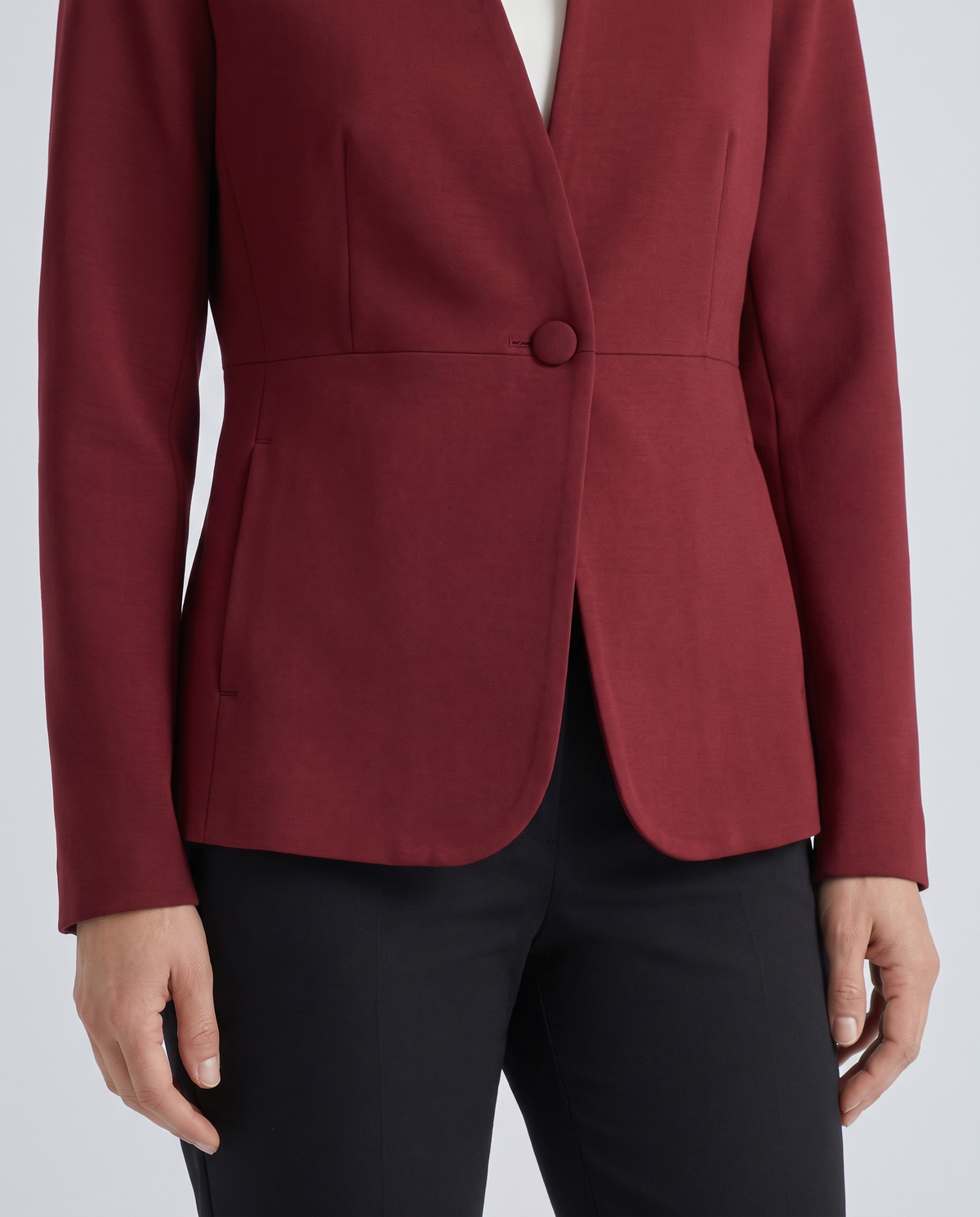 Oxblood collarless jacket, covered button and curved front detail