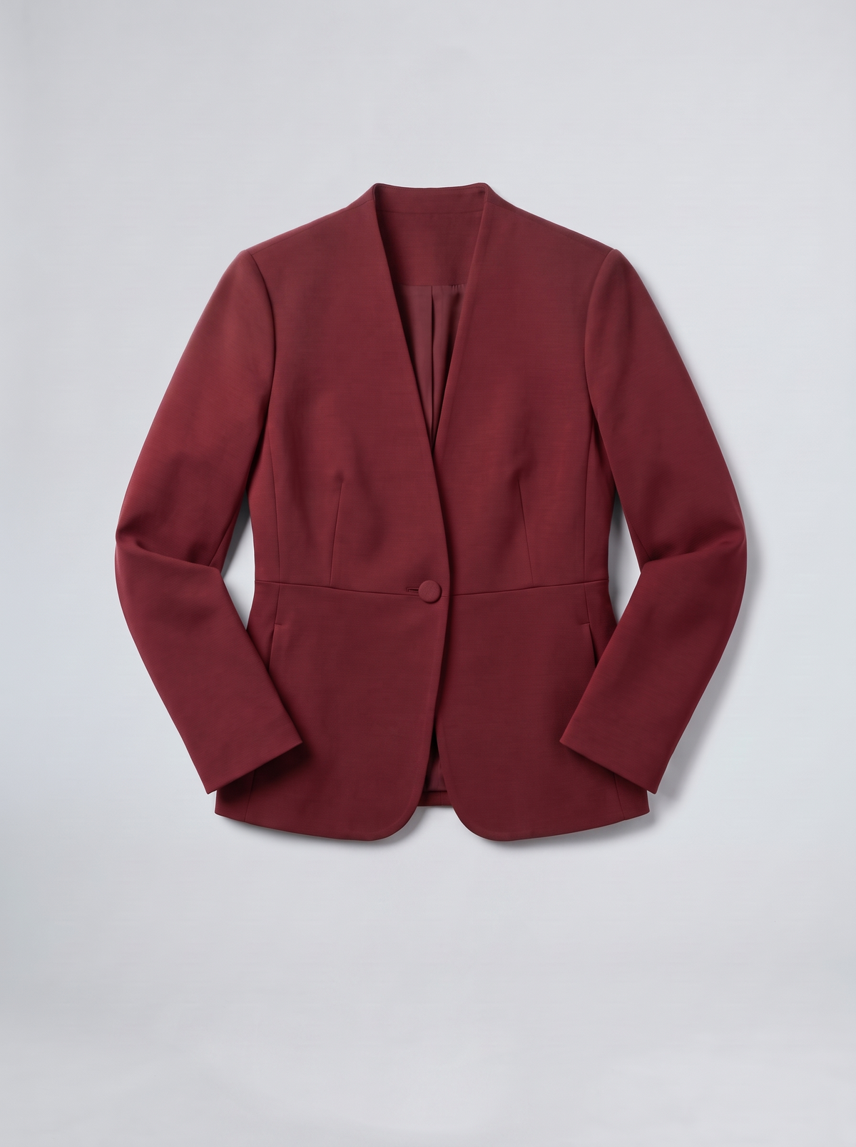Oxblood collarless jacket flat lay on a grey background
