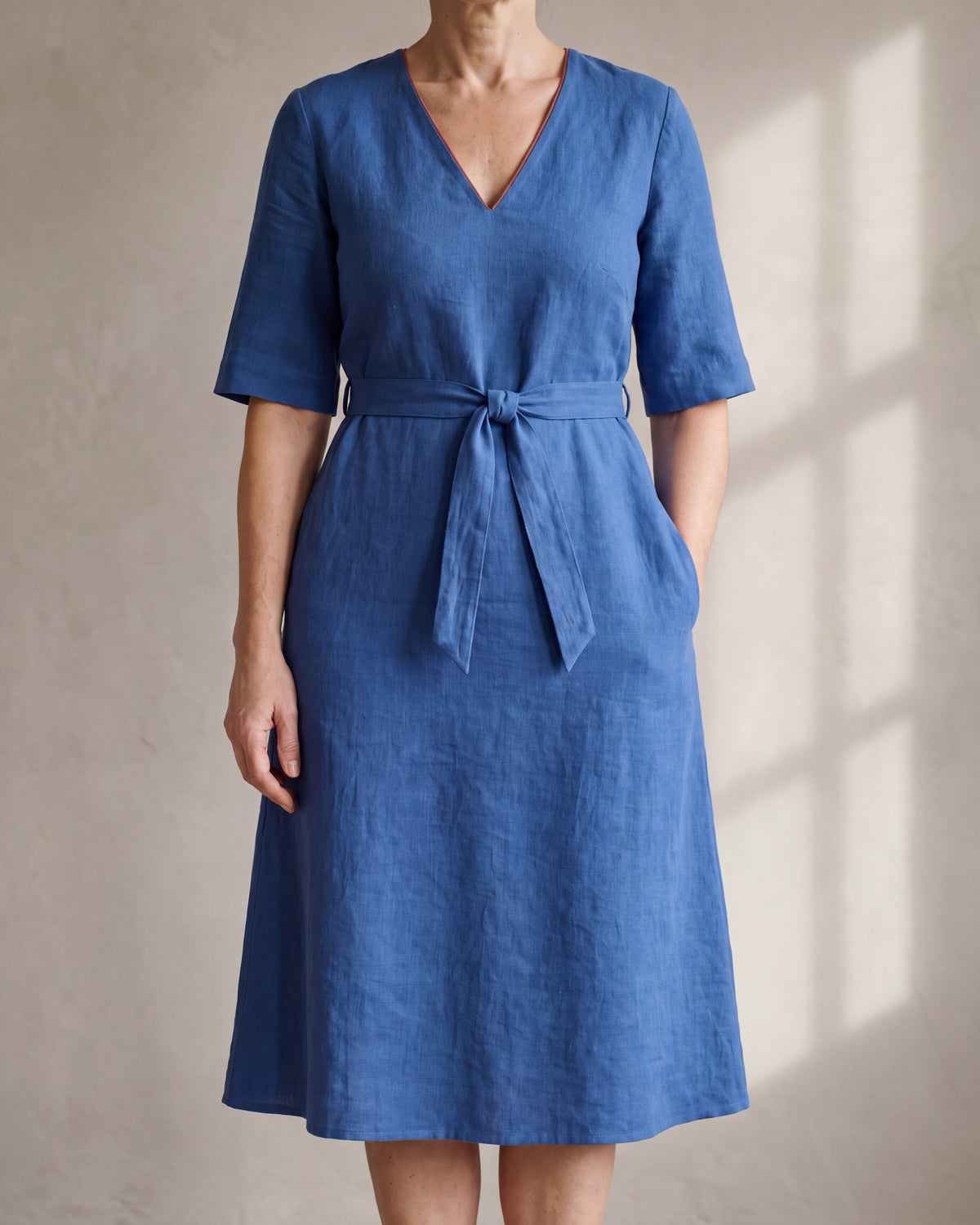 PASSPORT blue linen elbow-sleeve A-line midi dress with tie belt, close front view