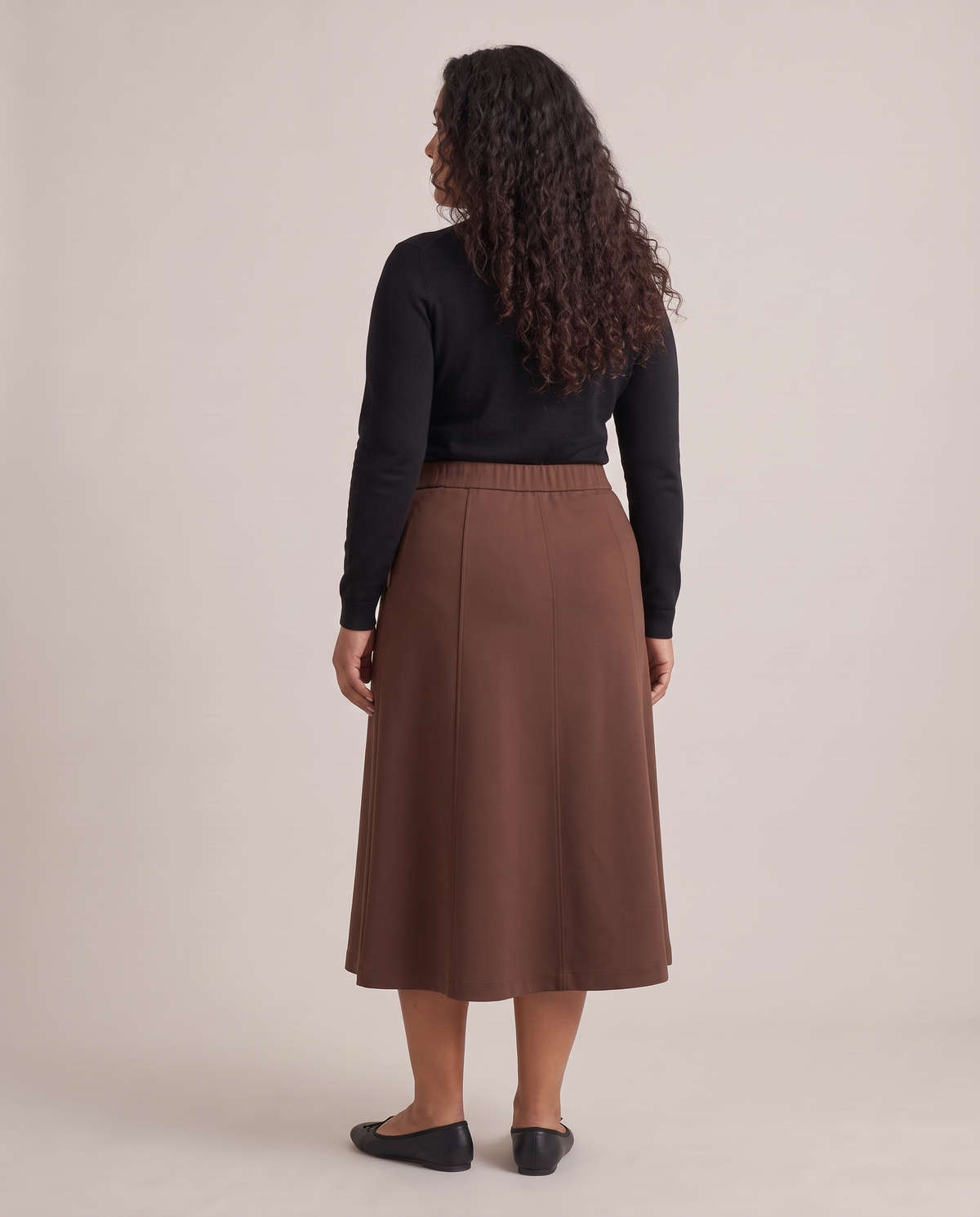 STEP midi skirt in Brown, back view with the elastic back waistband