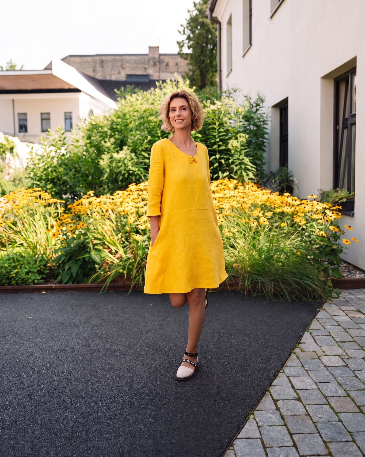 SUN – Linen Blend V-Neck Bow Dress – Yellow dress, front view, full length, in a flower garden #Color_Yellow
