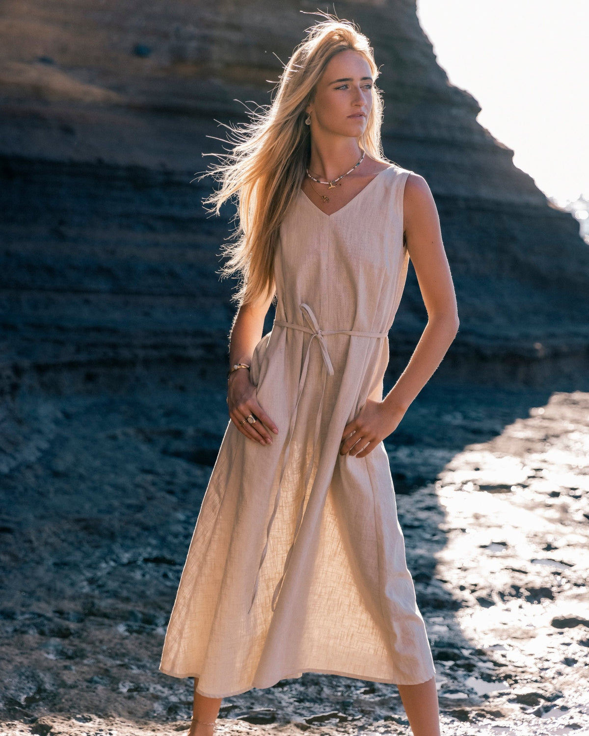 LeMuse SUNSET linen dress in beige – model front full length by the sea #Color_Beige