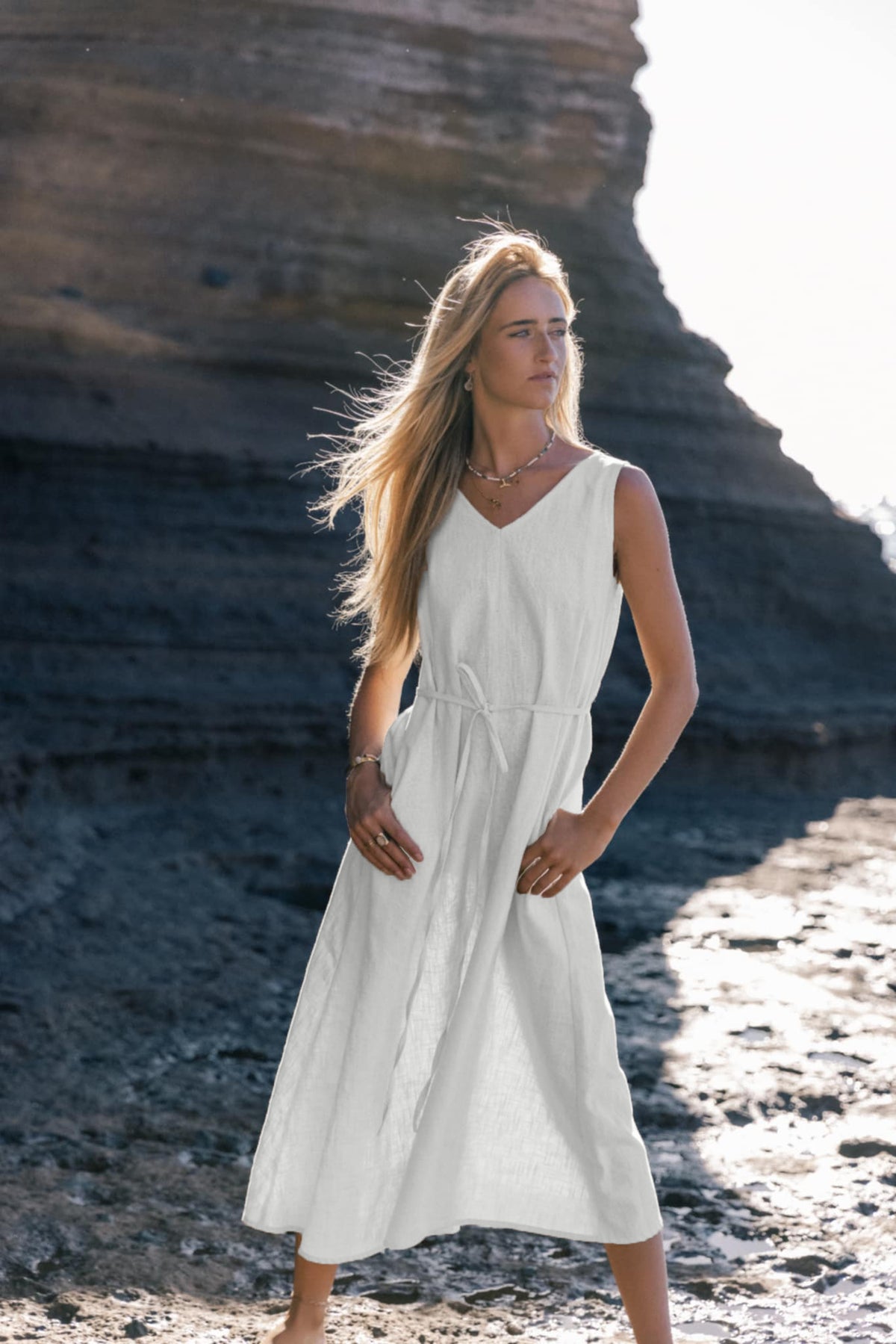 LeMuse SUNSET linen dress in white – model front full length by the sea #Color_White