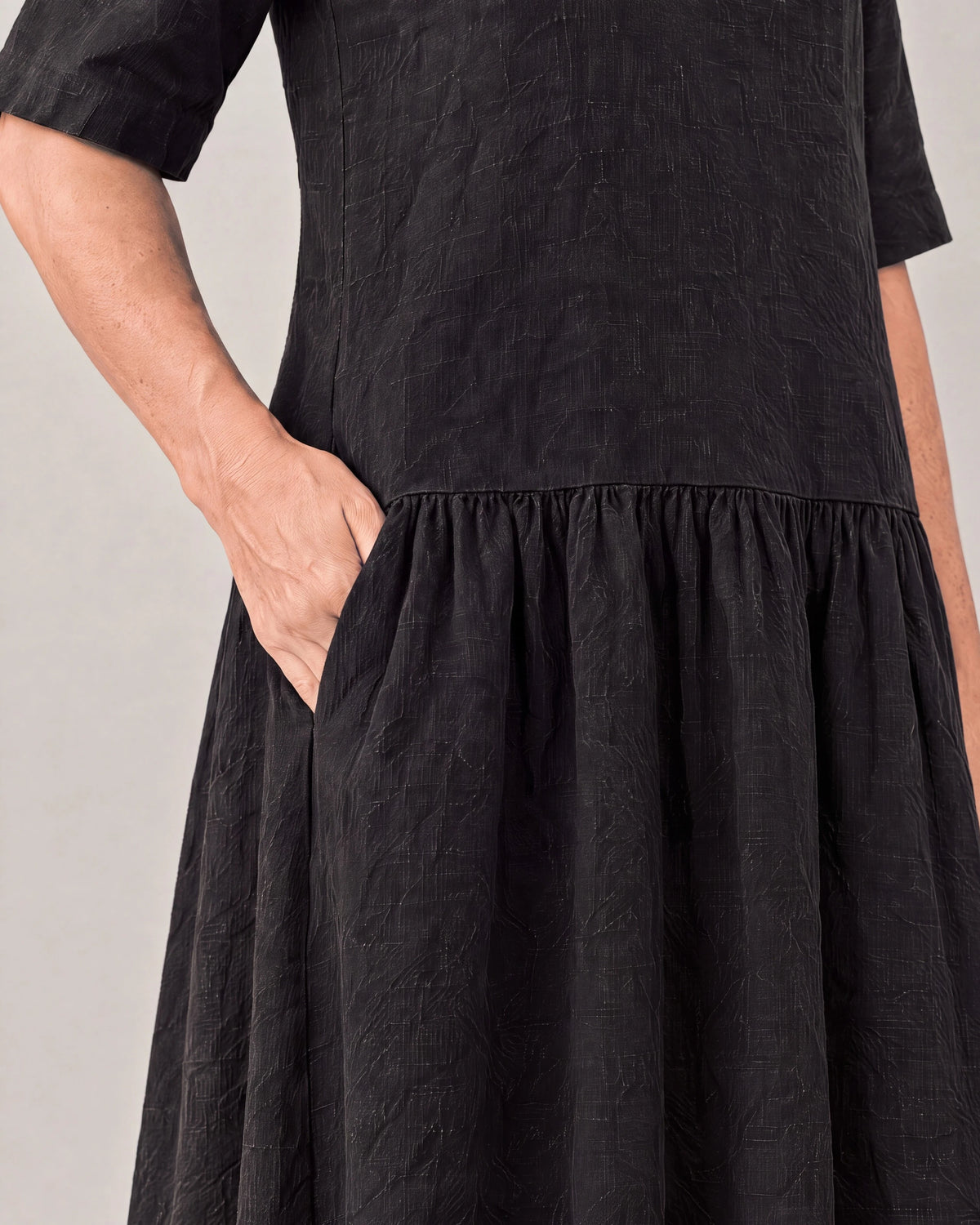 TESSA black linen tiered dress, detail of side-seam pocket and gathered tier