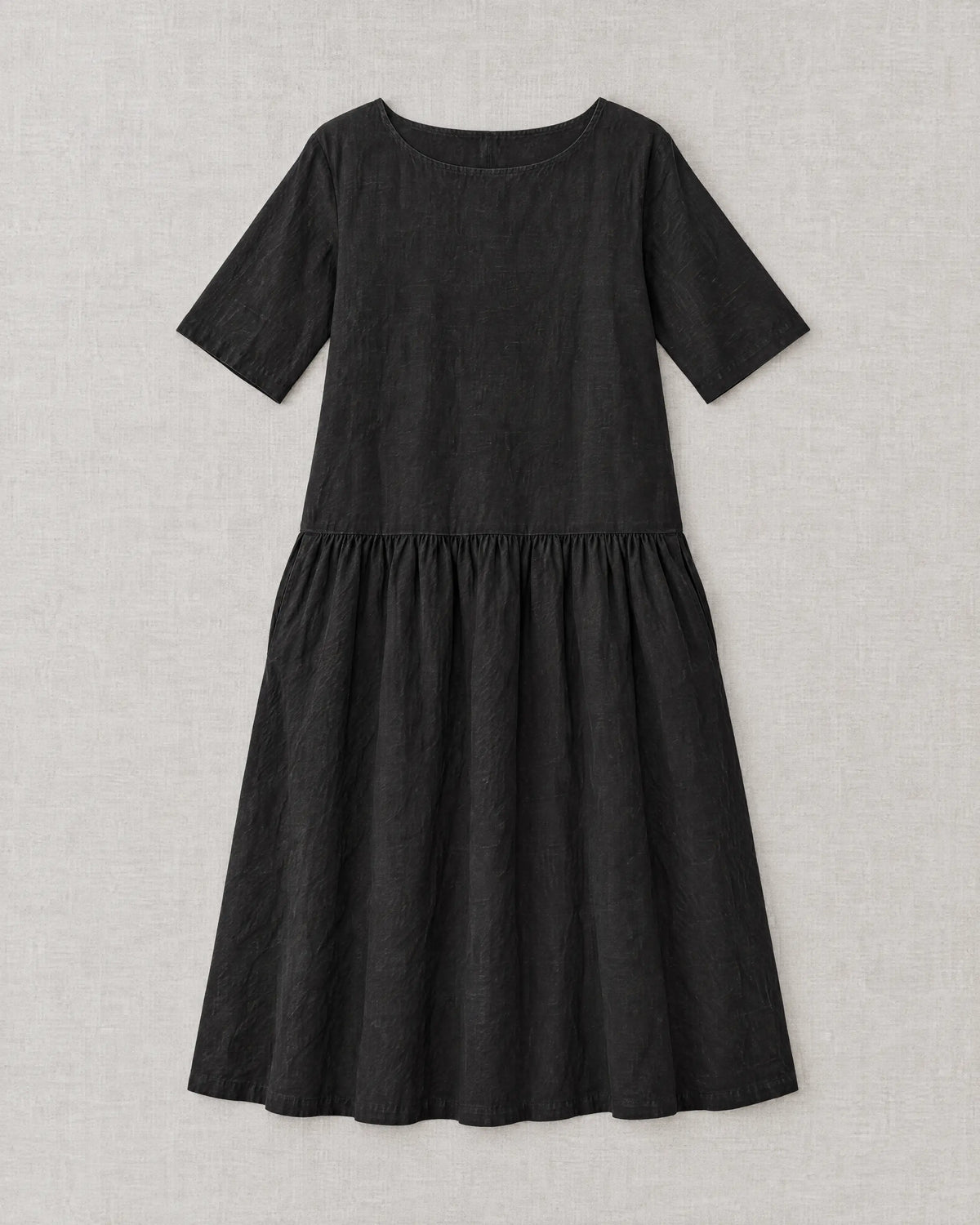 TESSA black linen tiered midi dress laid flat