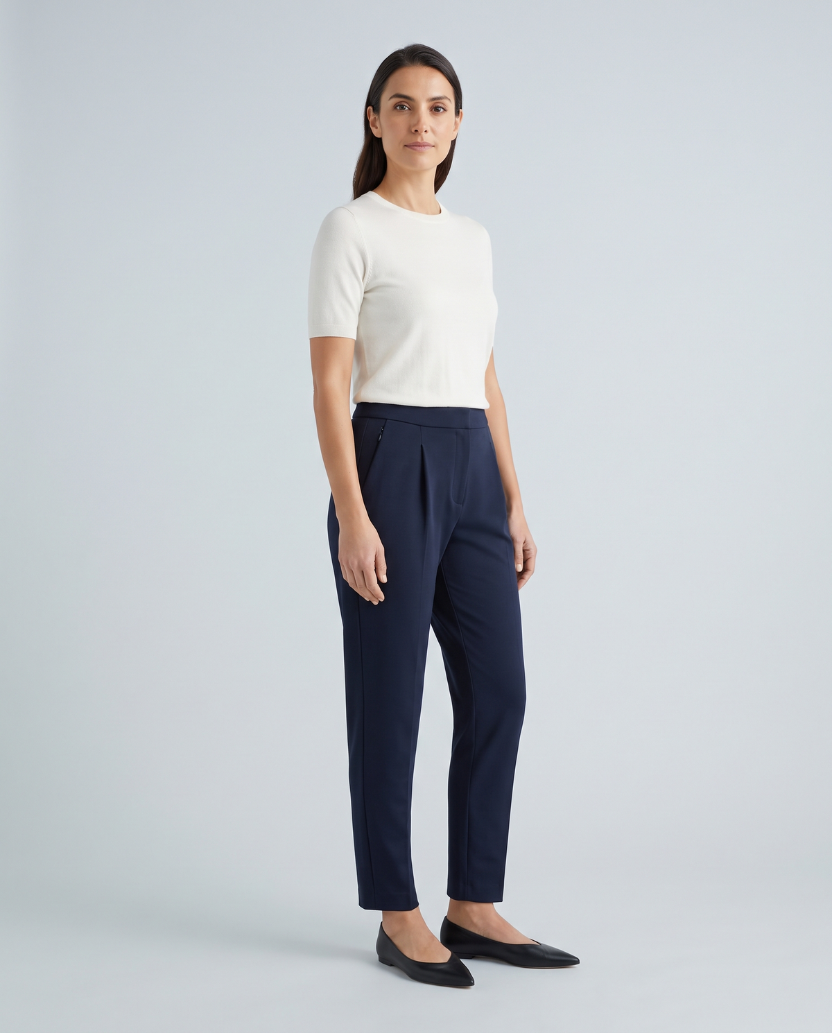 TRAVEL ink navy tapered trousers, full-length front view with shallow pleats and ankle-length hem